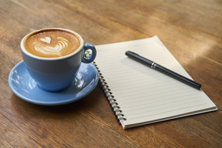 Content Creation Cup of coffee and notebook with pencil