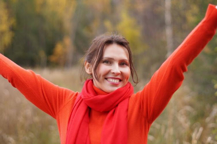 woman dressed in red smiling in success position