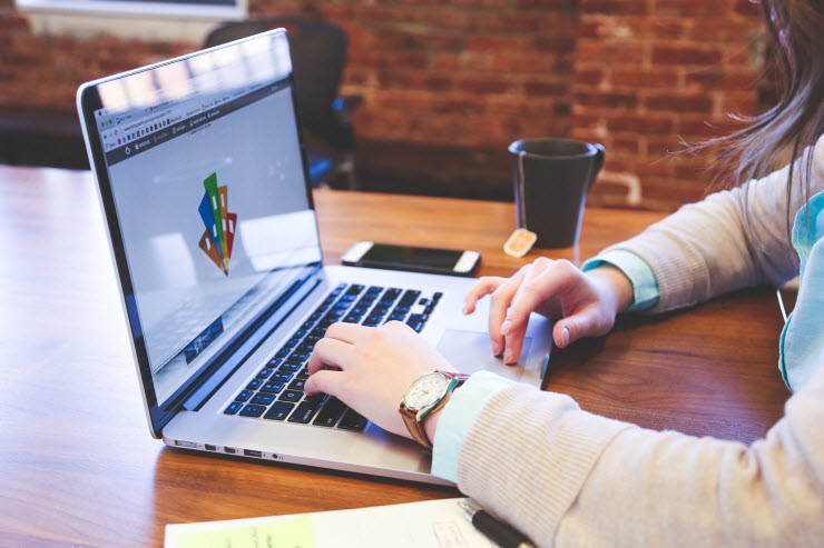 Woman writing on laptop